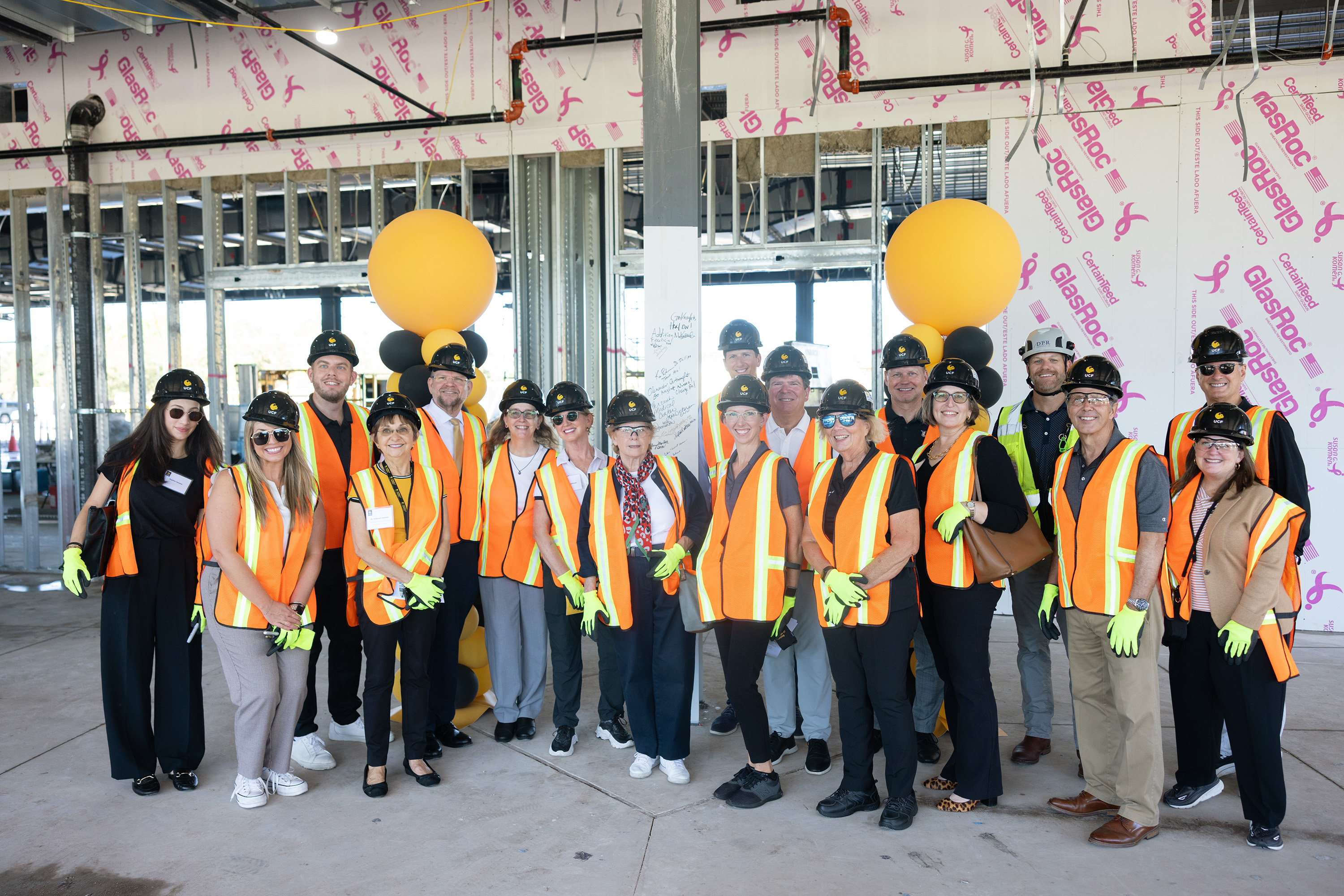 Group photo of potential donors and UCF College of Nursing leadershipinside the active jobsite