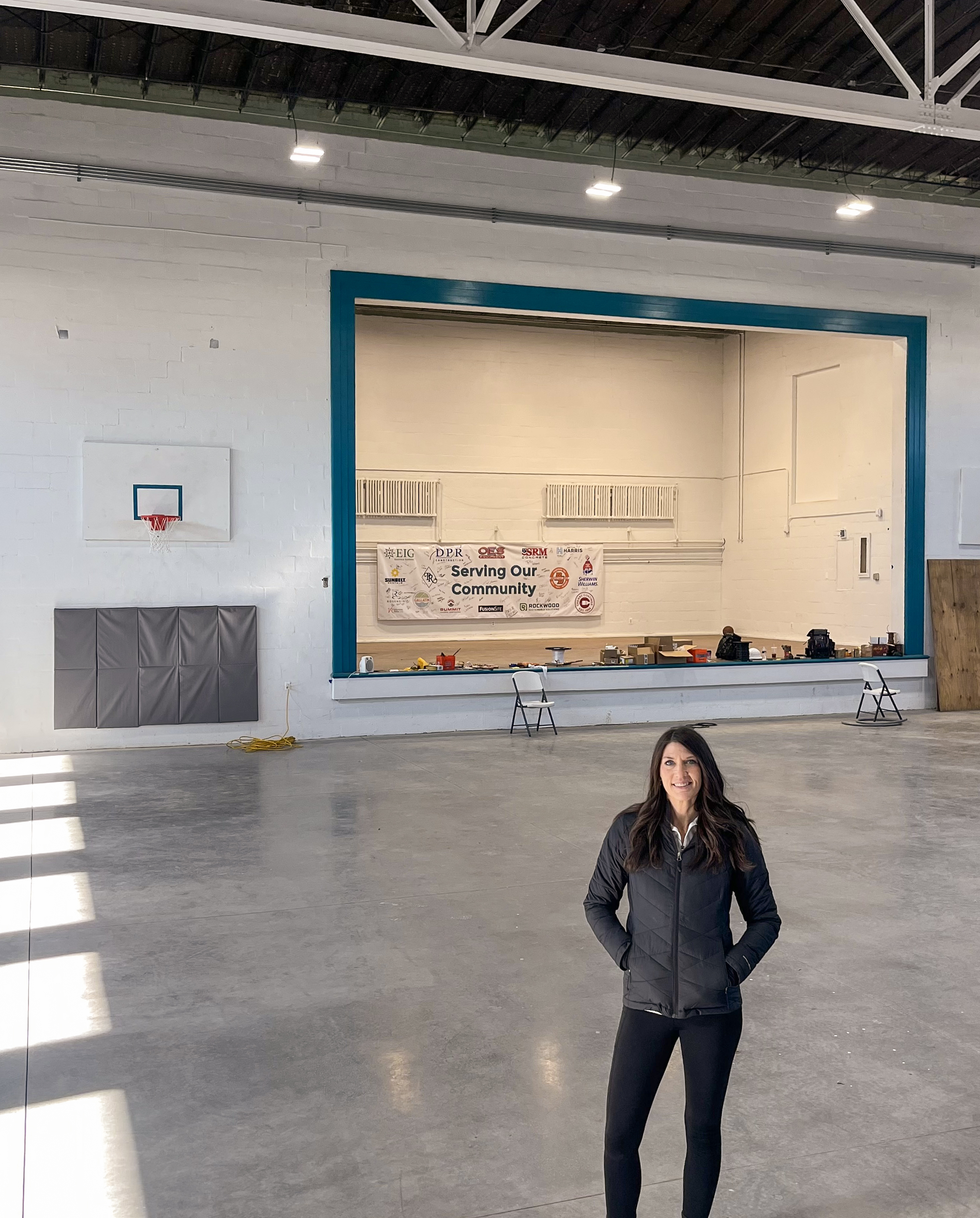Gallatin Shalom Zone Executive Director Bethany Sullivan stands in front of gymnasium